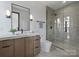 Modern bathroom featuring a glass shower and marble countertop vanity at 2536 Brawley School Rd, Mooresville, NC 28117