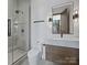 Modern bathroom featuring a glass shower and a sleek vanity with a stylish mirror at 2536 Brawley School Rd, Mooresville, NC 28117