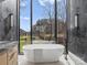 Modern bathroom with a soaking tub and expansive window for natural light and views at 2536 Brawley School Rd, Mooresville, NC 28117