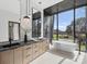 Contemporary bathroom with a double sink vanity, soaking tub, and expansive window at 2536 Brawley School Rd, Mooresville, NC 28117