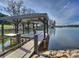 Dock on the lake featuring a covered seating area with a great view of the water at 2536 Brawley School Rd, Mooresville, NC 28117