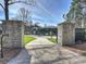 Grand entrance to the property with stone pillars and a secure gated driveway at 2536 Brawley School Rd, Mooresville, NC 28117