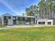 Modern home exterior with expansive lawn and a three-car garage at 2536 Brawley School Rd, Mooresville, NC 28117