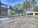 Stunning modern home with a paver driveway, two-car garage, stone accents, and walls of windows at 2536 Brawley School Rd, Mooresville, NC 28117