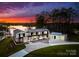 Stunning waterfront modern home with lush landscaping and a tranquil lake view at sunset at 2536 Brawley School Rd, Mooresville, NC 28117