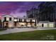 Modern home exterior with expansive lawn, lush trees, and a large garage at 2536 Brawley School Rd, Mooresville, NC 28117