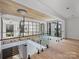 Bright foyer with hardwood floors, glass railings, and a modern light fixture at 2536 Brawley School Rd, Mooresville, NC 28117