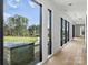 Hallway with hardwood floors and large windows overlooking the lawn at 2536 Brawley School Rd, Mooresville, NC 28117