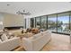 Bright living room with modern fireplace and large windows overlooking the lake at 2536 Brawley School Rd, Mooresville, NC 28117