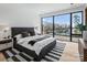 Bedroom with lake view, accent rug, and a large window at 2536 Brawley School Rd, Mooresville, NC 28117