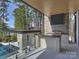 Outdoor kitchen with stone accents overlooks trees at 2536 Brawley School Rd, Mooresville, NC 28117