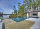Outdoor swimming pool featuring a shallow sunbathing area and a lake view at 2536 Brawley School Rd, Mooresville, NC 28117