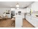 Modern kitchen with white cabinets, stainless steel appliances, and a functional center island at 3117 Williams Rd, Matthews, NC 28105