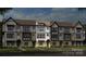 Stylish townhome with a modern facade, showcasing multiple windows and well-manicured landscaping at 344 Catawba Ave, Davidson, NC 28036