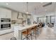 A modern kitchen with stainless steel appliances, a large kitchen island, pendant lighting, and an open-concept design at 344 Catawba Ave, Davidson, NC 28036