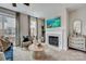 Inviting living room featuring a fireplace, a large-screen television, and access to the backyard at 344 Catawba Ave, Davidson, NC 28036