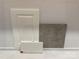 Selection of finishes: white cabinet door, white countertop sample, and grey tile sample at 344 Catawba Ave, Davidson, NC 28036