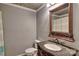Cozy bathroom featuring a decorative granite-topped vanity with carved accents and a framed mirror at 415 E Richland St, Kershaw, SC 29067