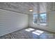 Bright room features wood-look ceiling, shiplap walls and wood-look flooring with natural light from double window at 415 E Richland St, Kershaw, SC 29067