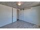 Clean room featuring wood-look ceiling, neutral walls, and a door to another room at 415 E Richland St, Kershaw, SC 29067