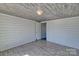 View of bedroom with plank ceiling, shiplap walls, wood-look flooring and a doorway leading to another room at 415 E Richland St, Kershaw, SC 29067