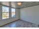 Bright room featuring wood-look ceiling, neutral walls, and two windows offering neighborhood views at 415 E Richland St, Kershaw, SC 29067