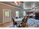 Open-concept space features a dining table, views of the kitchen and updated flooring at 415 E Richland St, Kershaw, SC 29067