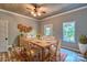 Cozy dining area featuring a wooden table, plaid chairs, wood-look floors, and a view of the outdoors at 415 E Richland St, Kershaw, SC 29067