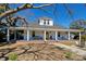 Charming single Gathering home with a welcoming front porch and a well-maintained yard and eye-catching yellow door at 415 E Richland St, Kershaw, SC 29067