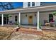 Inviting front porch featuring classic columns, rocking chairs, and a decorative wreath at 415 E Richland St, Kershaw, SC 29067