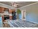 Efficient kitchen with wood-look floors, cabinetry, stainless steel appliances, and access to another room at 415 E Richland St, Kershaw, SC 29067