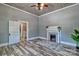 Spacious living room with fireplace and decorative rug; features wood-look ceiling and updated flooring at 415 E Richland St, Kershaw, SC 29067