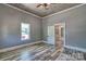 Bright living room featuring wood-look ceiling, modern flooring, and an open doorway to a connected room at 415 E Richland St, Kershaw, SC 29067