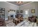 Cozy living room featuring wood-look floors, a fireplace, and comfortable seating arrangement, perfect for relaxing at 415 E Richland St, Kershaw, SC 29067