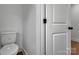 Bathroom featuring white toilet, white door, and modern fixtures at 425 Messner St, Salisbury, NC 28144