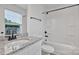 Bathroom with white vanity, granite counters and tub shower combo with black hardware at 425 Messner St, Salisbury, NC 28144