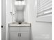 Bright bathroom featuring a granite vanity top with a single sink and white cabinets below at 425 Messner St, Salisbury, NC 28144