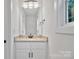 Bright bathroom featuring white cabinets, granite counters, modern fixtures, and ample natural light at 425 Messner St, Salisbury, NC 28144