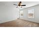 Bedroom featuring two windows, ceiling fan, neutral carpet, and white walls at 425 Messner St, Salisbury, NC 28144