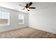 Bedroom featuring neutral carpet, two windows, ceiling fan, and white walls at 425 Messner St, Salisbury, NC 28144