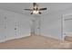 Spacious bedroom with a fan, neutral carpet and two entry doors at 425 Messner St, Salisbury, NC 28144