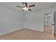 Bedroom with ceiling fan, tan carpet and view into an adjacent bathroom at 425 Messner St, Salisbury, NC 28144