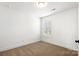 A bright bedroom features neutral carpet, white walls, and a window that provides natural light at 425 Messner St, Salisbury, NC 28144