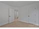 A carpeted bedroom with white walls and trim includes two doors and neutral carpeting at 425 Messner St, Salisbury, NC 28144