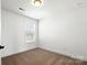 A bright bedroom features neutral carpet, white walls, and a window that provides natural light at 425 Messner St, Salisbury, NC 28144