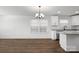 Dining area with chandelier and new hardwood floors with access to the modern kitchen at 425 Messner St, Salisbury, NC 28144