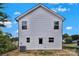 View of the back exterior of a two-story home, with white siding and a door leading to the yard at 425 Messner St, Salisbury, NC 28144
