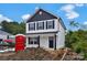 A new home with white siding and black trim sits on a construction site at 425 Messner St, Salisbury, NC 28144