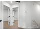 Hallway featuring carpeted floors, a doorway, and white doors with black hardware at 425 Messner St, Salisbury, NC 28144