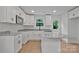 Bright kitchen features white cabinets, granite countertops, stainless appliances, and a kitchen island at 425 Messner St, Salisbury, NC 28144